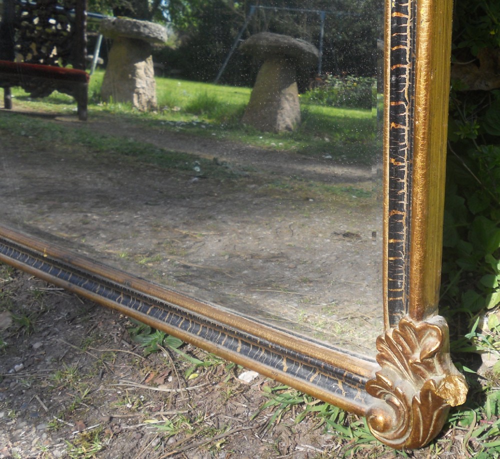 A large rectangular gold gilt wall mirror featuring an ornate shell and leaf carved crest. View IX