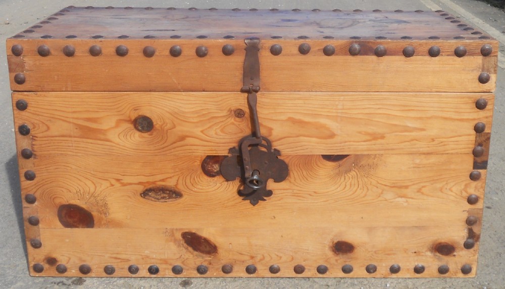 A rectangular Victorian pine wooden blanket box featuring studded iron trim along the edges, side drop handles, and an iron latch on the front. View III