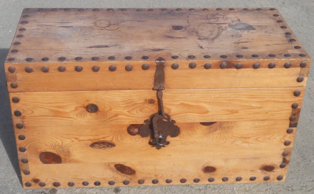 A rectangular Victorian pine wooden blanket box featuring studded iron trim along the edges, side drop handles, and an iron latch on the front. View IV