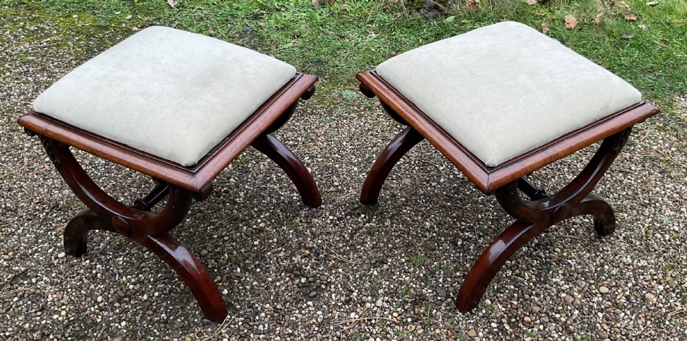 A pair of William IV mahogany x-frame stools with neutral light beige upholstered padded tops and turned central stretchers. View V