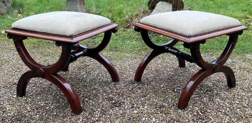 A pair of William IV mahogany x-frame stools with neutral light beige upholstered padded tops and turned central stretchers. View VII