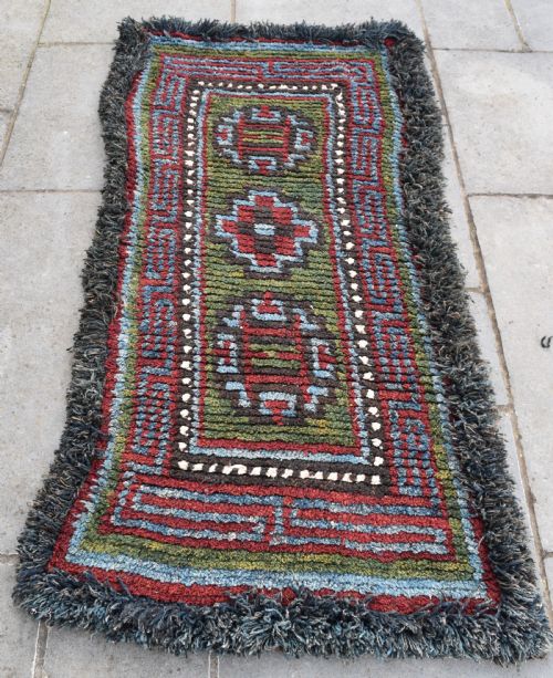 a rare green ground tibetan monastic seating mat from the wangden valley tibet - CATEGORY: ANTIQUE RUGS - DATED 1870