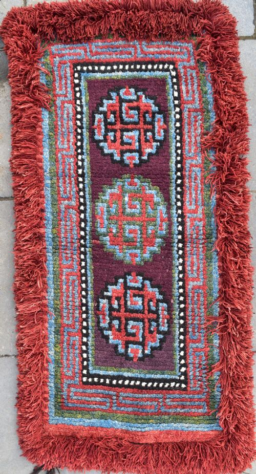 a very rare purple ground monastic seating mat from the wangden valley in tibet - CATEGORY: ANTIQUE RUGS - DATED 1850