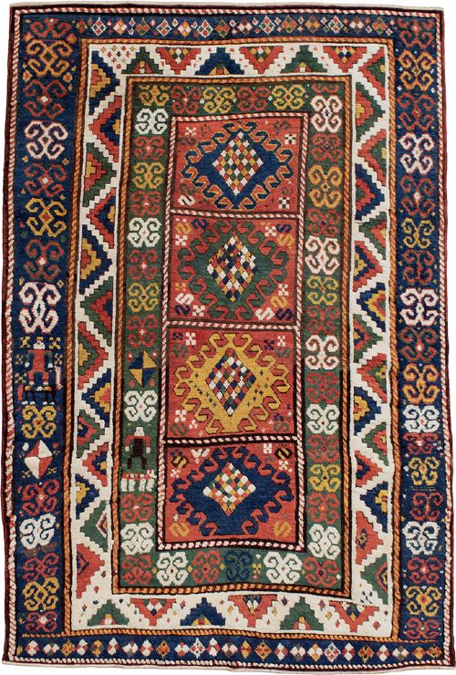 An antique Borchalu Kazak wool rug featuring stacked central diamond medallions surrounded by geometric borders in red, blue, green, and cream. View II