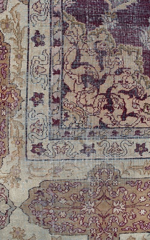 A large hand-knotted wool carpet featuring a central starburst medallion surrounded by floral motifs on a deep magenta field with a broad cream patterned border. View VIII