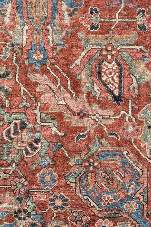 An antique Persian Heriz wool carpet featuring a central geometric medallion on a terracotta field surrounded by a dark navy decorative border. View VI
