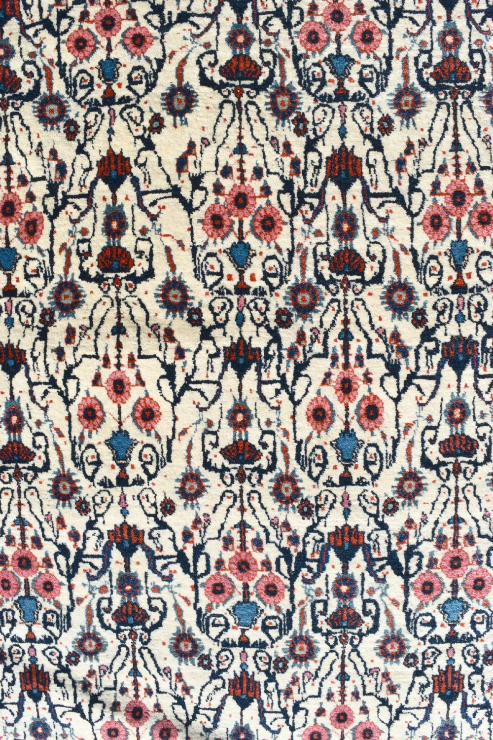An antique Persian Tehran carpet featuring an intricate overall floral pattern in tones of ivory, blue, and red with a detailed multi-stripe border. View V