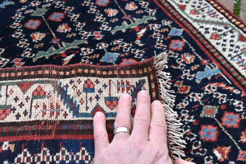 An antique Northwest Persian wool runner rug featuring repeating geometric shrub motifs on a navy blue field framed by a cream border. View IX