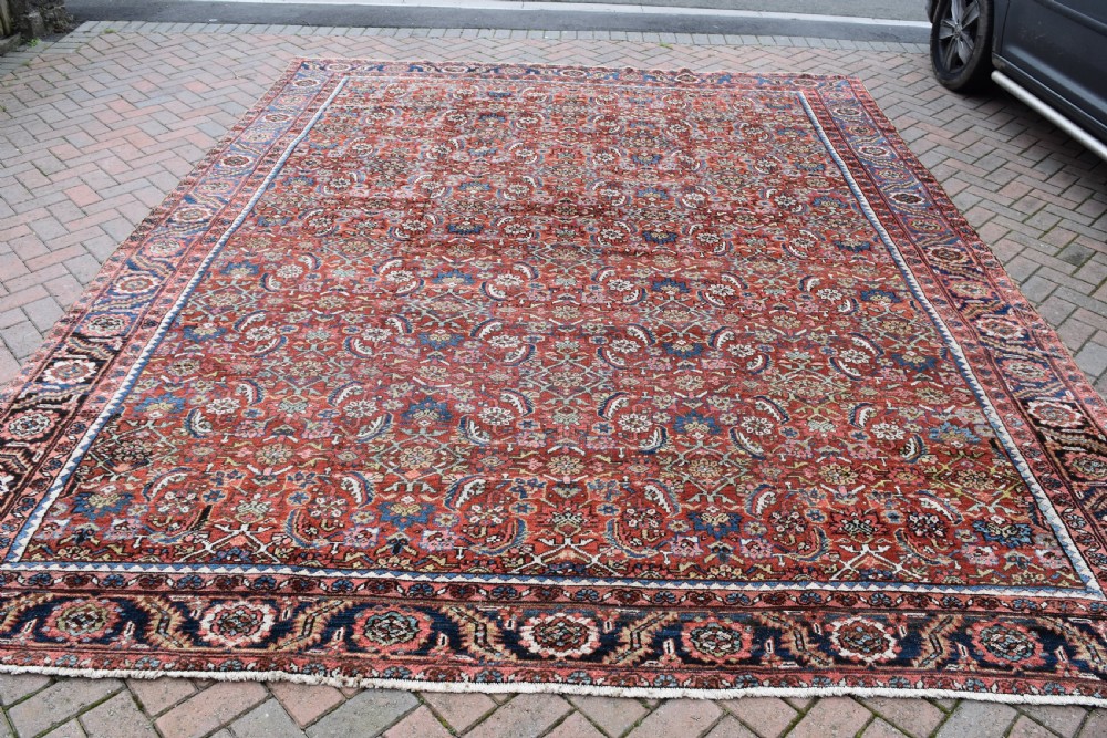 An antique Persian Heriz carpet 385x314cm
