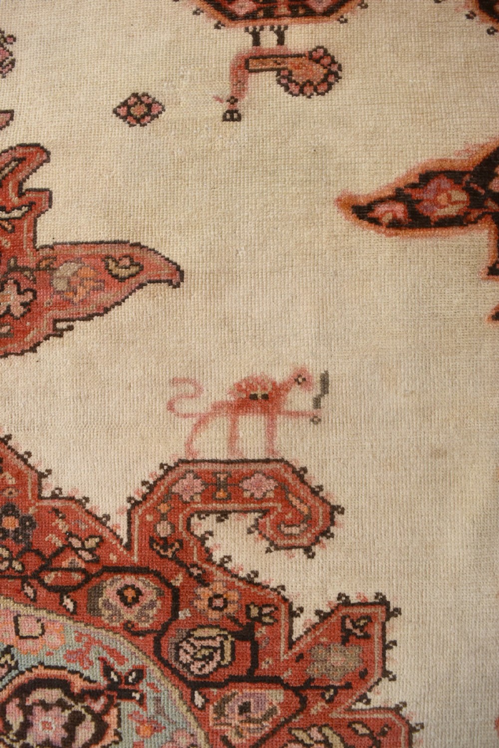 An antique Persian Malayer hand-knotted wool rug featuring a central stepped medallion, stylized lion motifs, and an ivory field framed by terracotta borders. View II