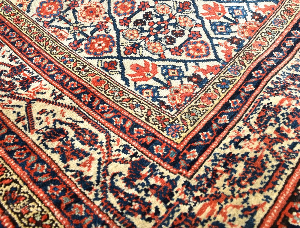 An antique long North West Persian Kelleh carpet featuring an intricate repeating lattice geometric motif in terracotta, navy blue, and cream tones. View VII