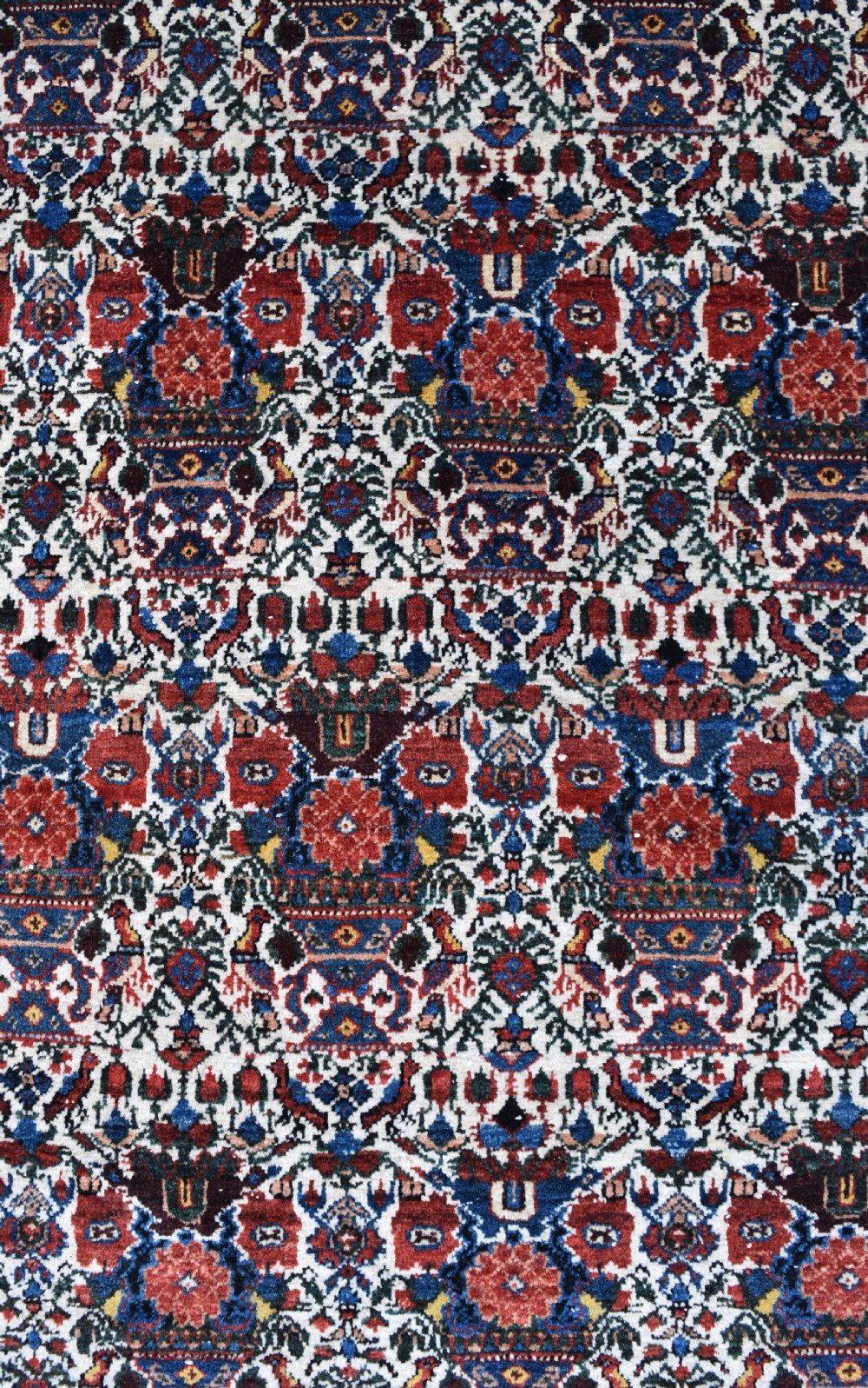 An antique Persian Abadeh hand-knotted wool carpet displaying an intricate repeating floral motif across an ivory field with terracotta and navy borders. View II