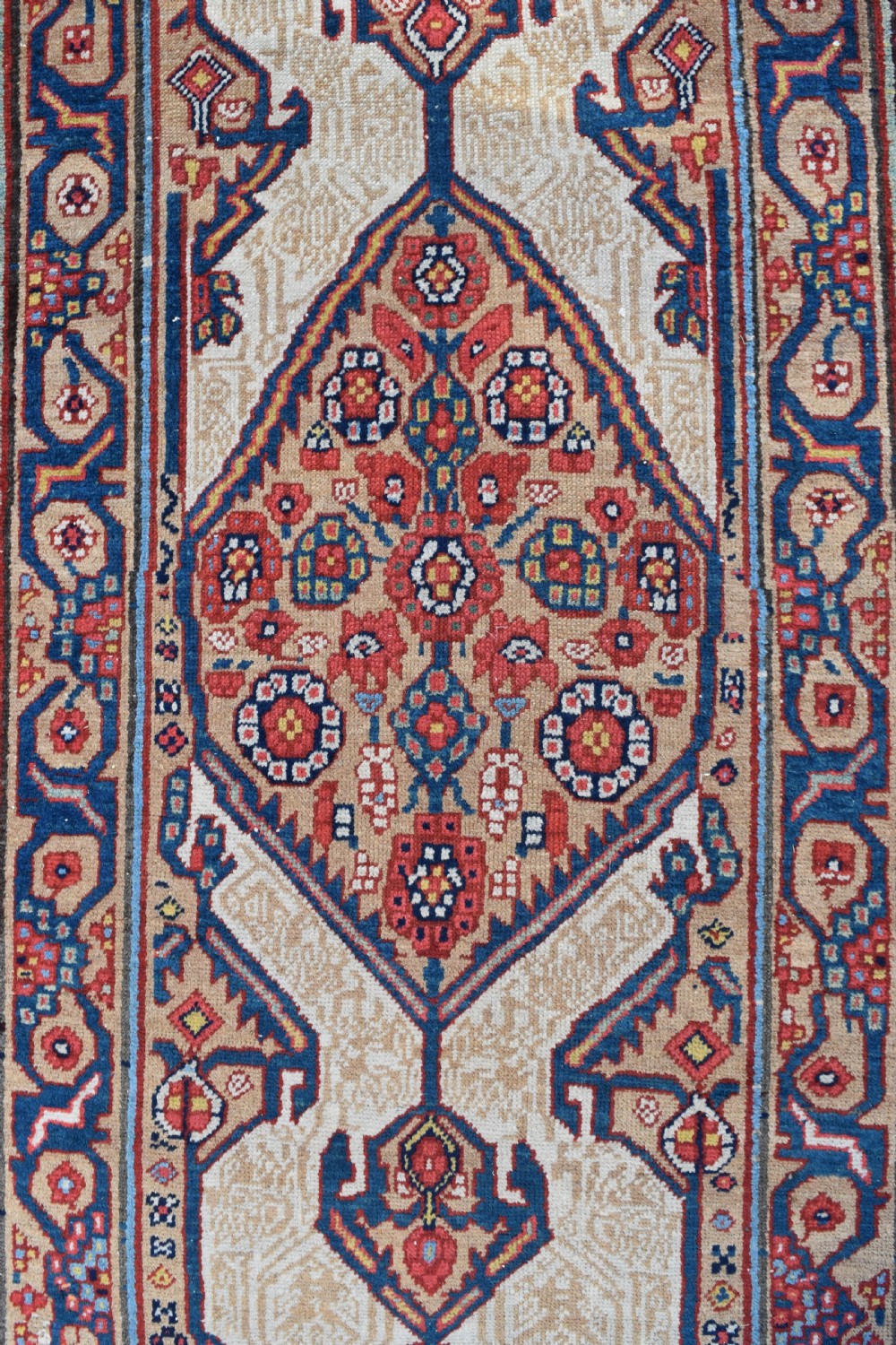 An extra long antique hand-knotted Persian Serab runner rug with geometric diamond medallions on a beige ground with terracotta and indigo accents. View II