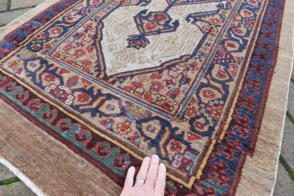 An extra long antique hand-knotted Persian Serab runner rug with geometric diamond medallions on a beige ground with terracotta and indigo accents. View IV
