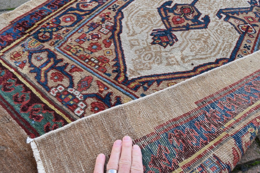 An extra long antique hand-knotted Persian Serab runner rug with geometric diamond medallions on a beige ground with terracotta and indigo accents. View V