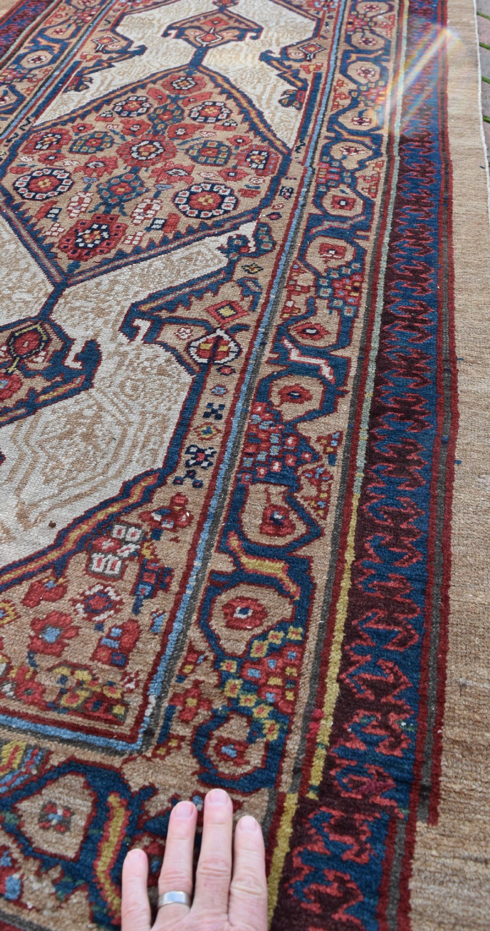 An extra long antique hand-knotted Persian Serab runner rug with geometric diamond medallions on a beige ground with terracotta and indigo accents. View VI