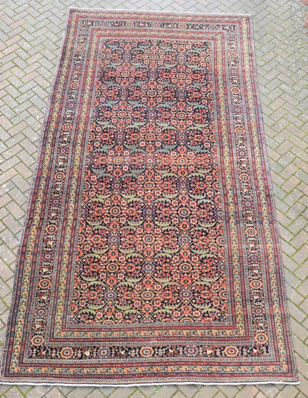 An antique North West Persian roomsize carpet 410x213cm