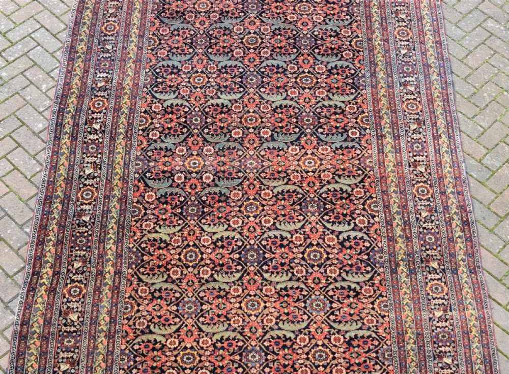 An antique North West Persian roomsize carpet 410x213cm View II