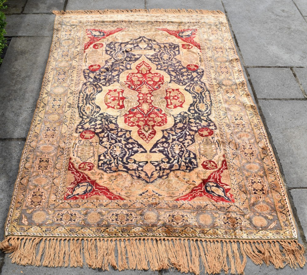 An antique hand-knotted Turkish Sivas rug featuring a central crimson medallion surrounded by navy spandrels and detailed floral borders in beige and blue tones. View II