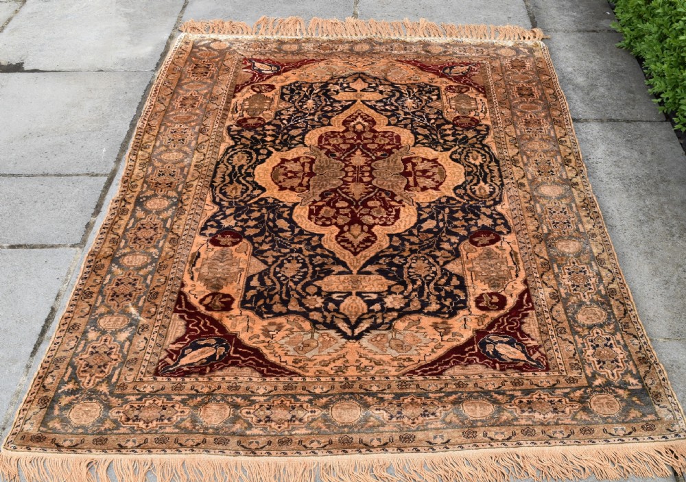 An antique hand-knotted Turkish Sivas rug featuring a central crimson medallion surrounded by navy spandrels and detailed floral borders in beige and blue tones. View III