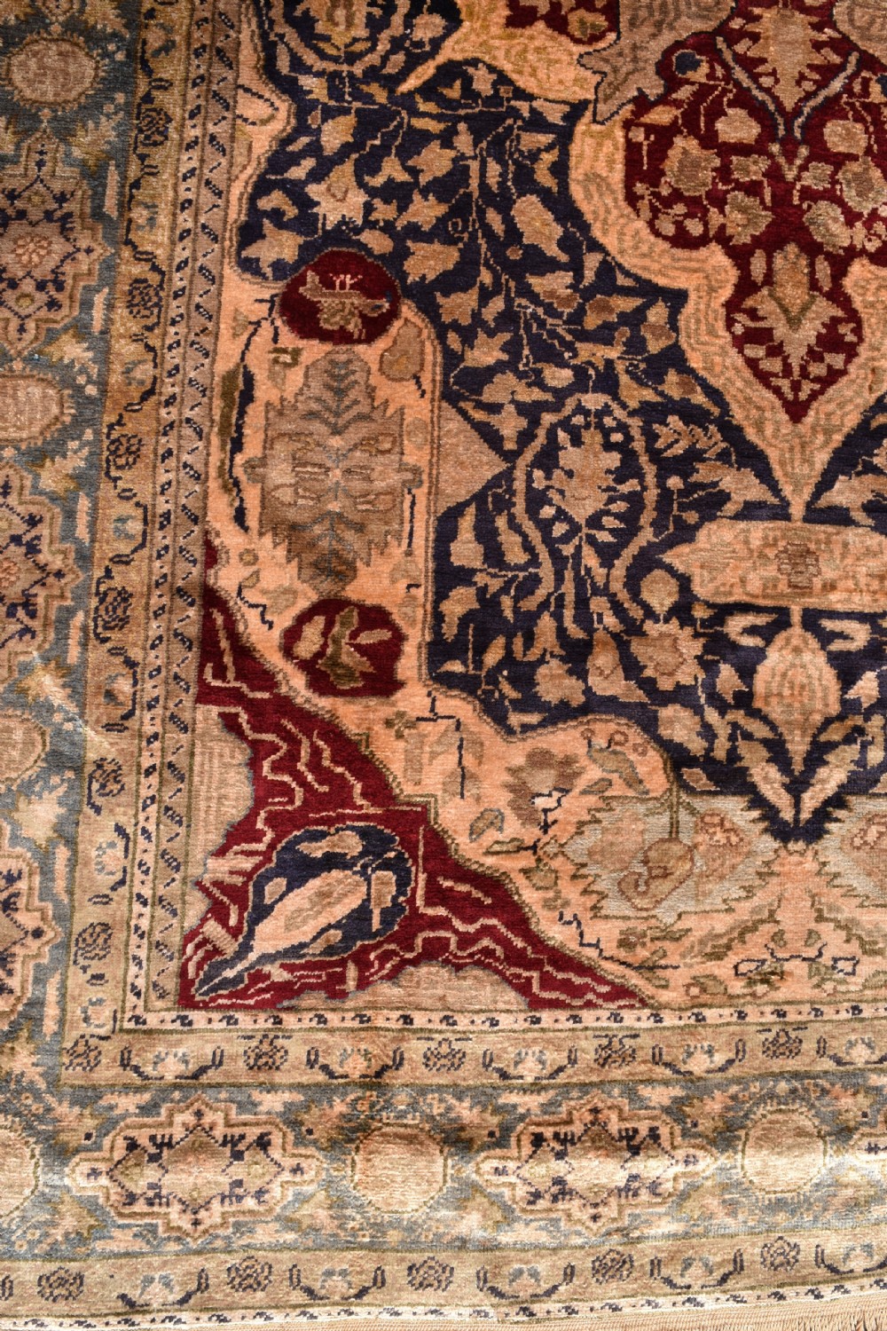 An antique hand-knotted Turkish Sivas rug featuring a central crimson medallion surrounded by navy spandrels and detailed floral borders in beige and blue tones. View IV