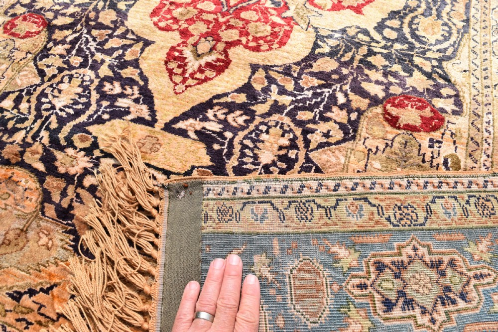 An antique hand-knotted Turkish Sivas rug featuring a central crimson medallion surrounded by navy spandrels and detailed floral borders in beige and blue tones. View VI