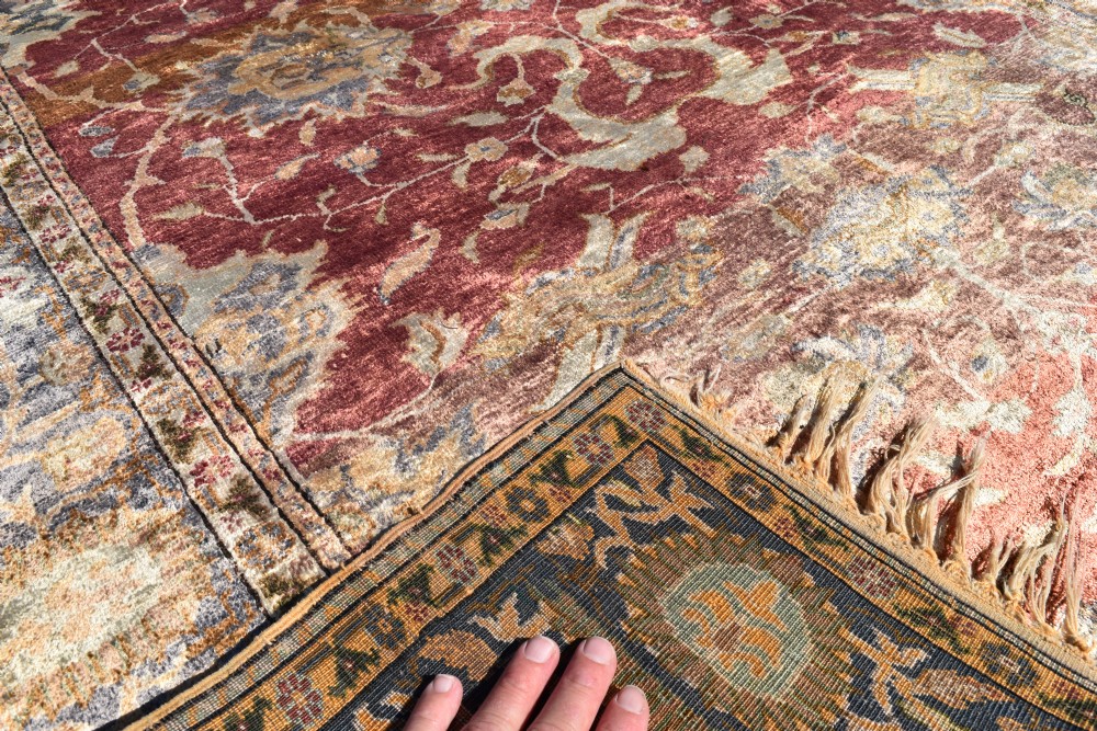 An antique rectangular Turkish Kayseri silk rug featuring an intricate floral central field in red and gold framed by a slate grey border with fringe along the ends. View IV