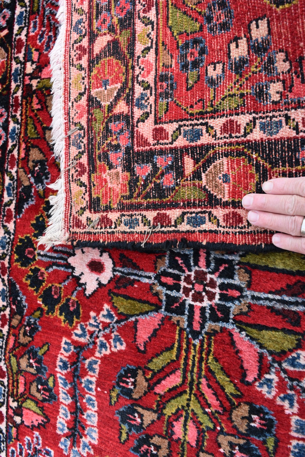 An exceptionally long hand-knotted Persian Sarouk runner rug featuring a deep red ground with detailed floral motifs and a multi-tiered dark border. View IV