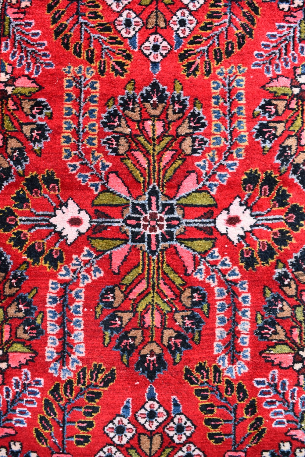 An exceptionally long hand-knotted Persian Sarouk runner rug featuring a deep red ground with detailed floral motifs and a multi-tiered dark border. View V