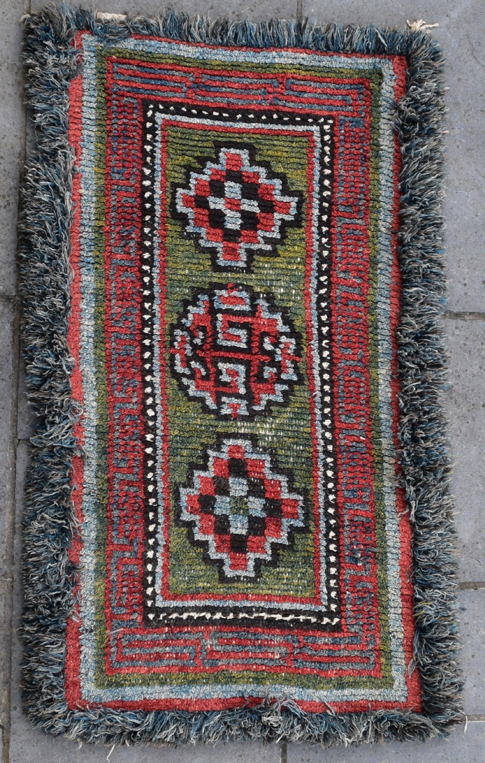 A rare green ground monastic seating mat from the Wangden valley, Tibet.