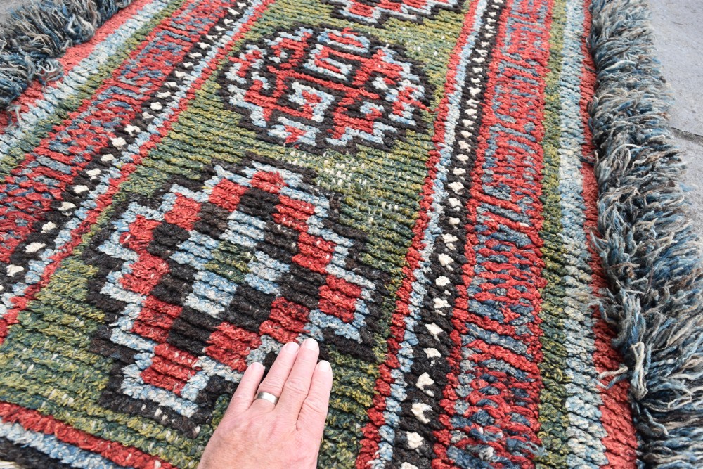 A rare green ground monastic seating mat from the Wangden valley, Tibet. View IV
