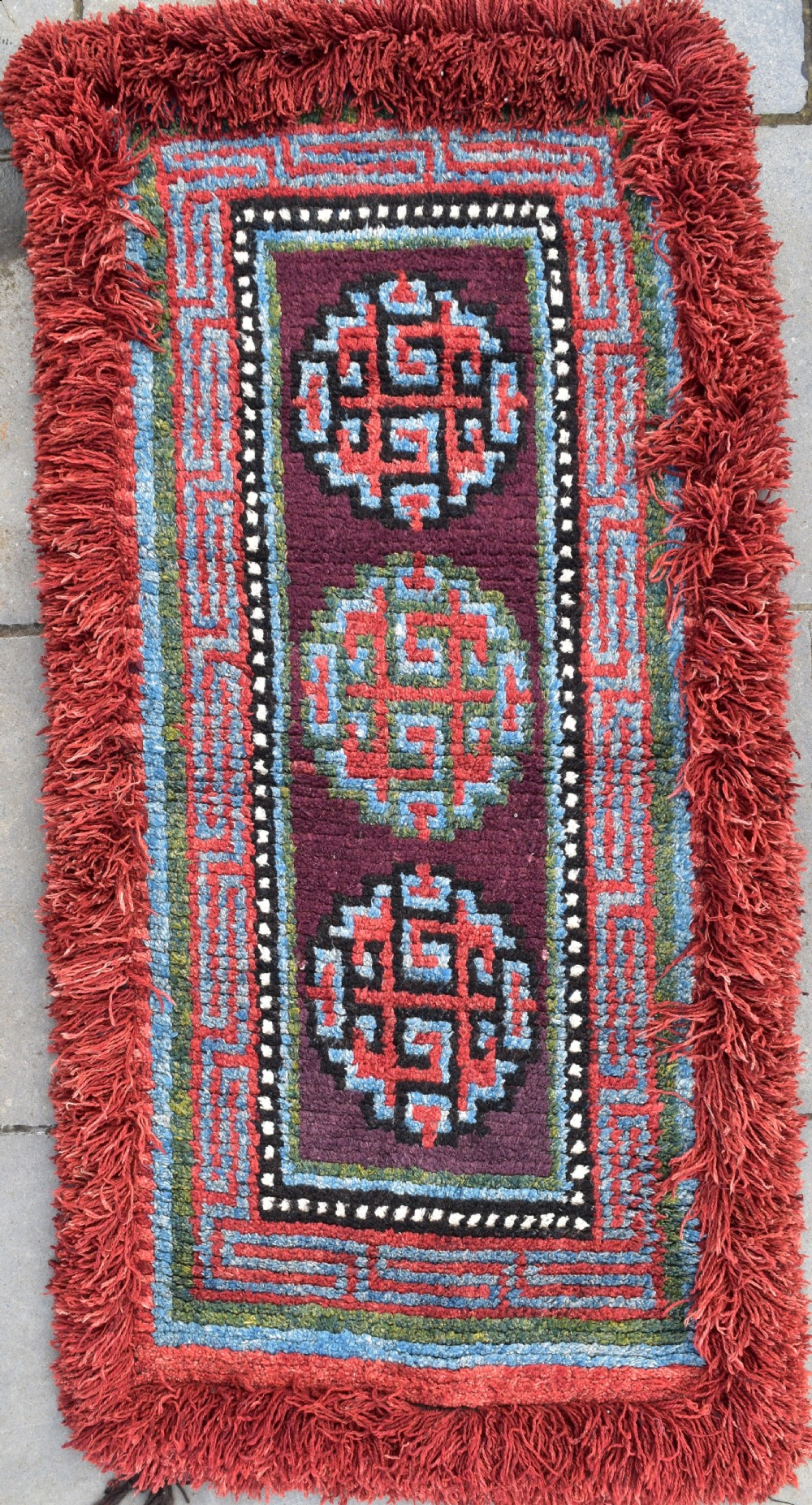 A very rare purple ground monastic seating mat from the Wangden valley in Tibet