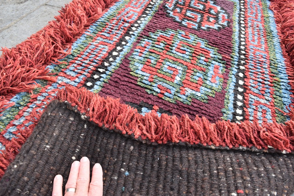 A very rare purple ground monastic seating mat from the Wangden valley in Tibet View IV