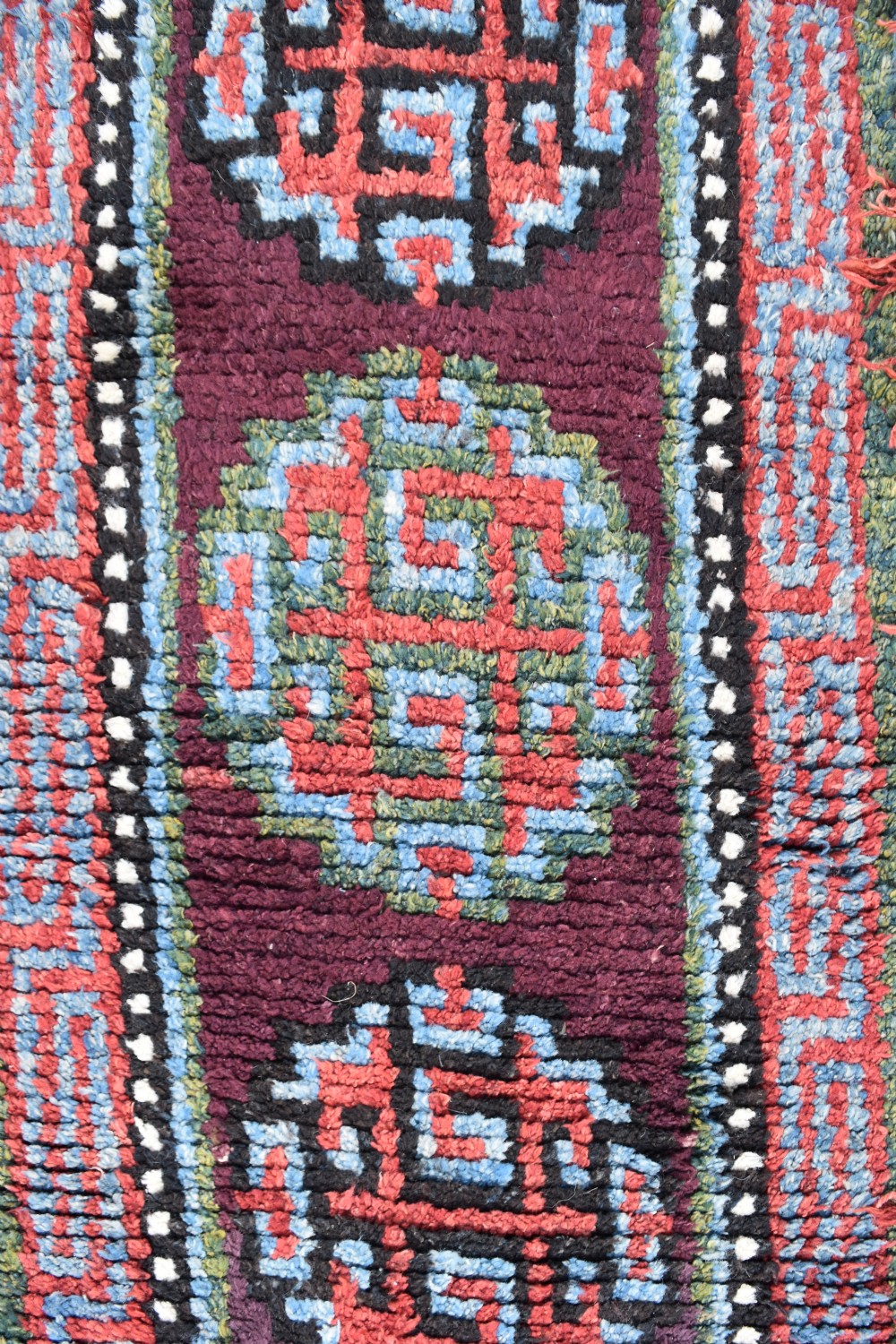A very rare purple ground monastic seating mat from the Wangden valley in Tibet View V