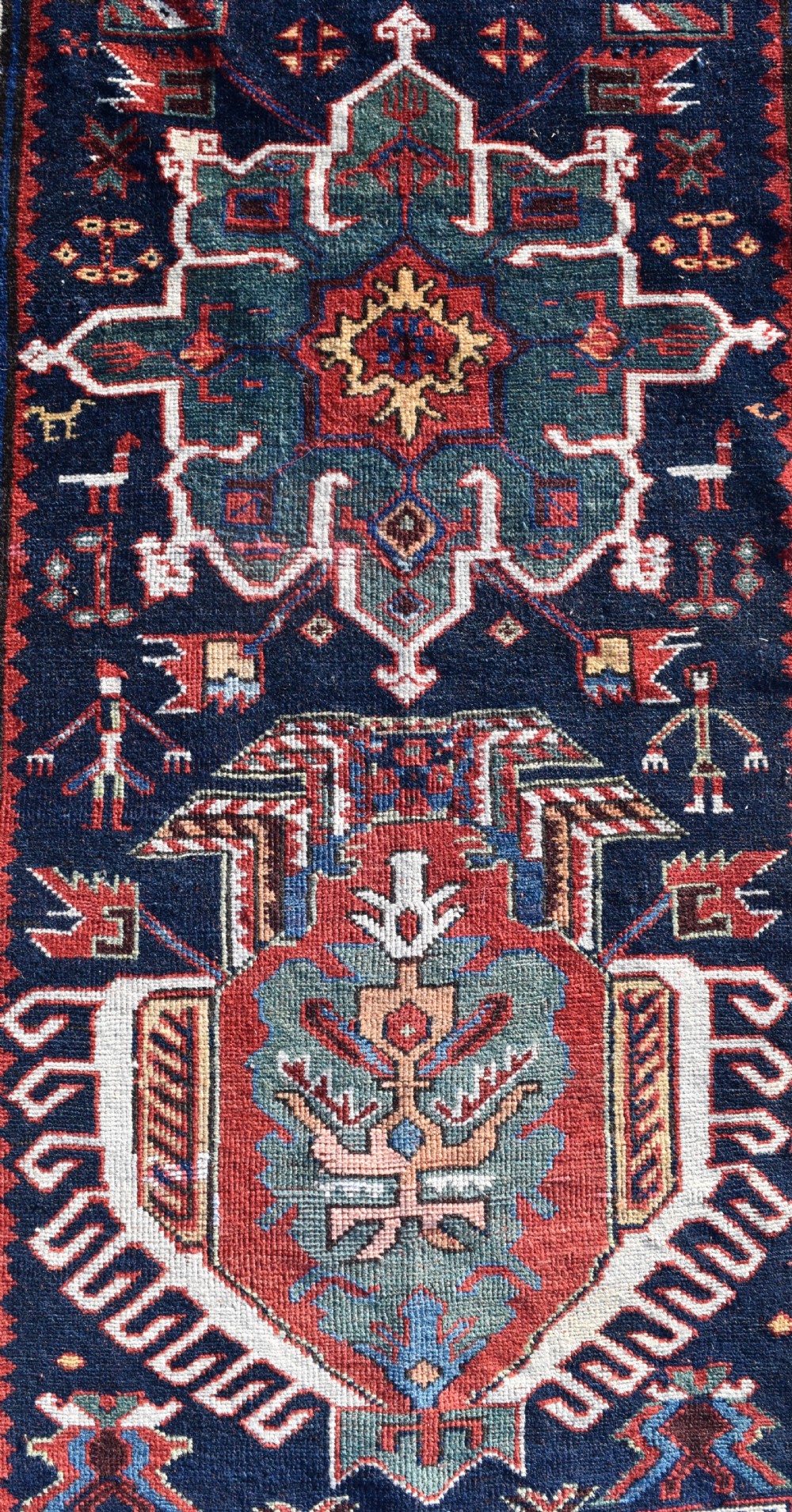 An antique Karadagh hand-knotted wool runner rug featuring geometric medallions on a navy blue central field framed by a wide terracotta red patterned border. View II