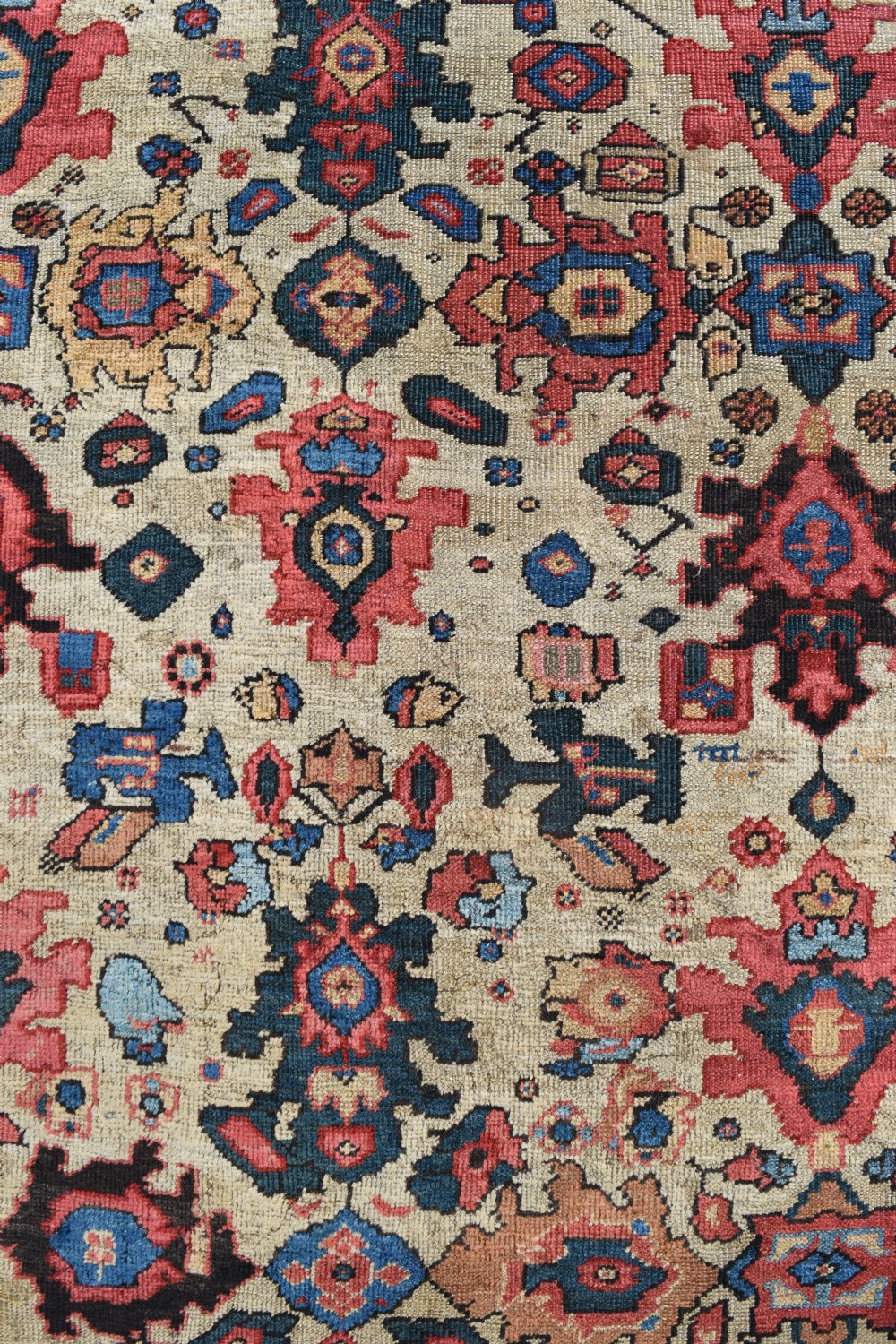 A large square hand-knotted antique Ferahan wool carpet featuring an all-over repeating geometric and floral pattern on a cream field, framed by a wide navy blue border. View II