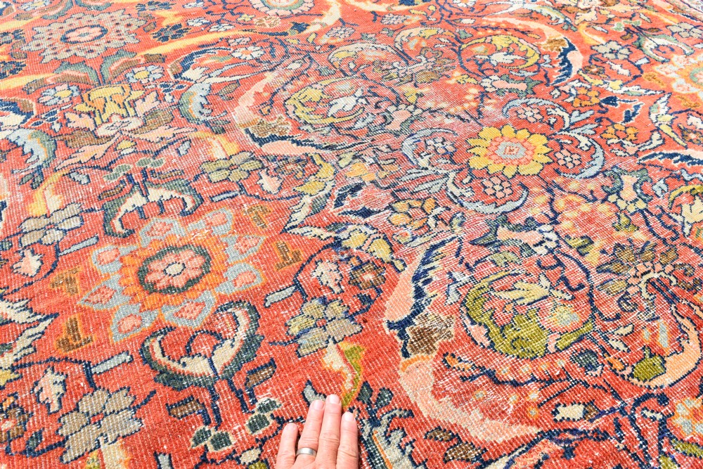 An oversized antique Persian Mahal wool carpet with a floral arabesque pattern on a terracotta field and a dark navy border. View IV