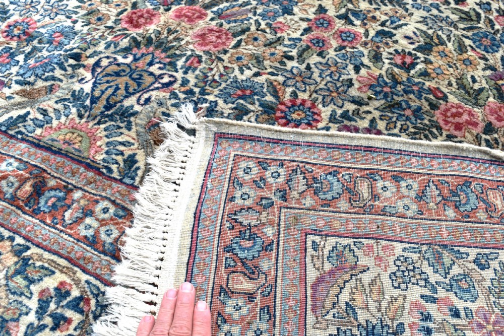 A large hand-knotted Persian Kirman room-size carpet featuring an intricate floral and vase pattern in cream, rose pink, and slate blue. View IX