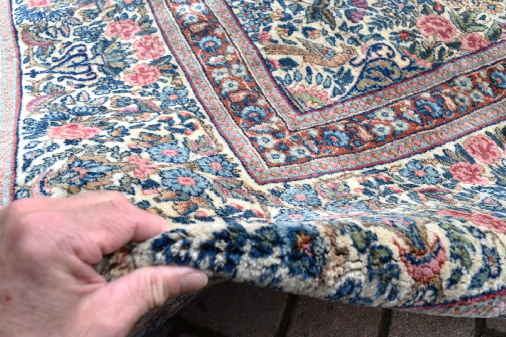 A large hand-knotted Persian Kirman room-size carpet featuring an intricate floral and vase pattern in cream, rose pink, and slate blue. View XI
