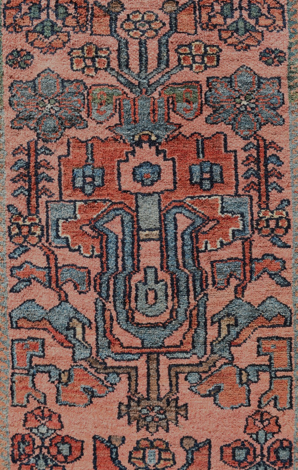 A pair of exceptionally long, narrow antique Persian Hamadan runners featuring intricate geometric and stylized floral motifs in blue and ivory on a terracotta wool ground. View VII