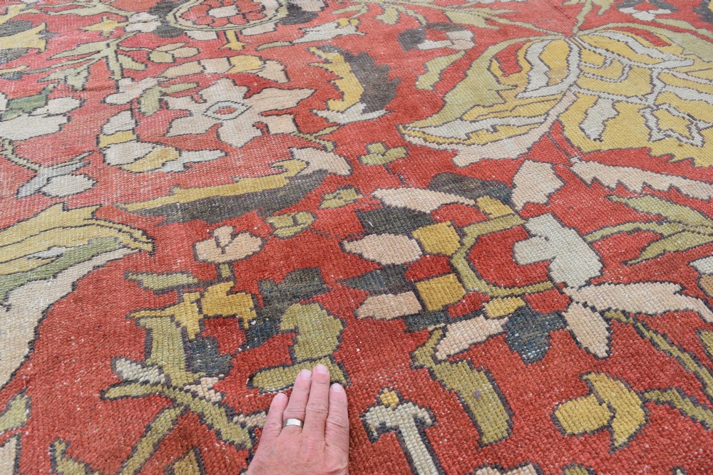 A large antique Persian Sultanabad hand-knotted wool carpet with large botanical palmettes on a terracotta field enclosed by multi-band borders. View III