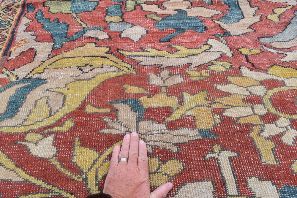 A large antique Persian Sultanabad hand-knotted wool carpet with large botanical palmettes on a terracotta field enclosed by multi-band borders. View VII
