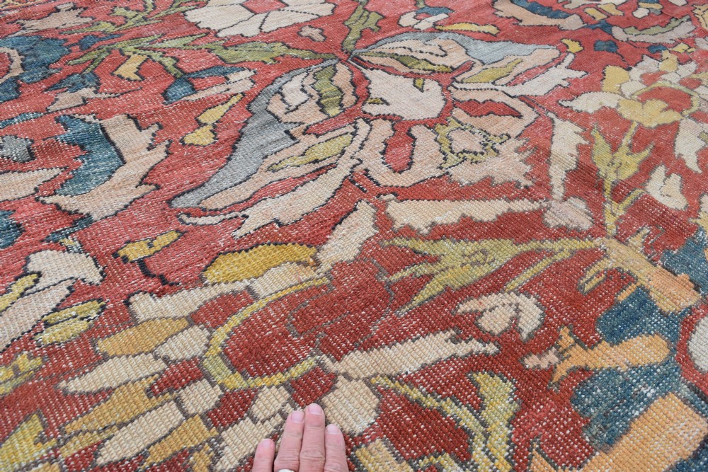 A large antique Persian Sultanabad hand-knotted wool carpet with large botanical palmettes on a terracotta field enclosed by multi-band borders. View VIII