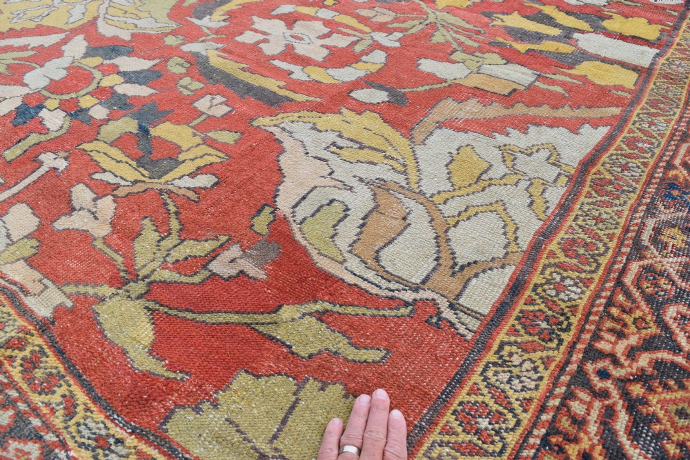 A large antique Persian Sultanabad hand-knotted wool carpet with large botanical palmettes on a terracotta field enclosed by multi-band borders. View XI