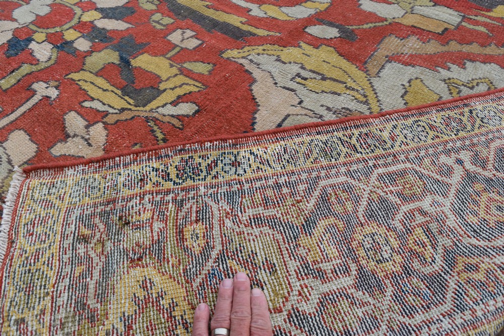 A large antique Persian Sultanabad hand-knotted wool carpet with large botanical palmettes on a terracotta field enclosed by multi-band borders. View XII
