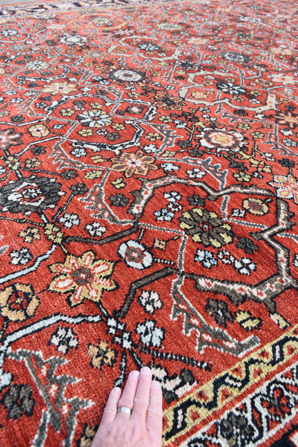 A large rectangular antique Mahal carpet featuring an all-over intricate floral lattice pattern in terracotta red and cream framed by a wide navy border. View IV