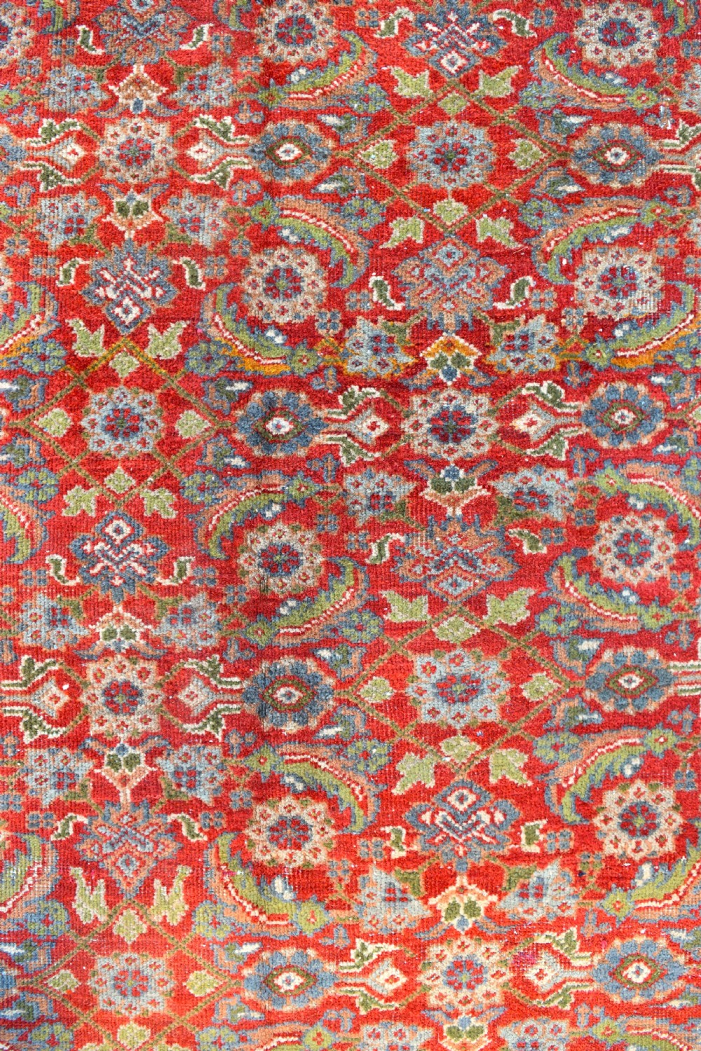 A large rectangular hand-knotted Sultanabad rug featuring an all-over floral lattice pattern on a terracotta red field with a slate blue palmette border. View III
