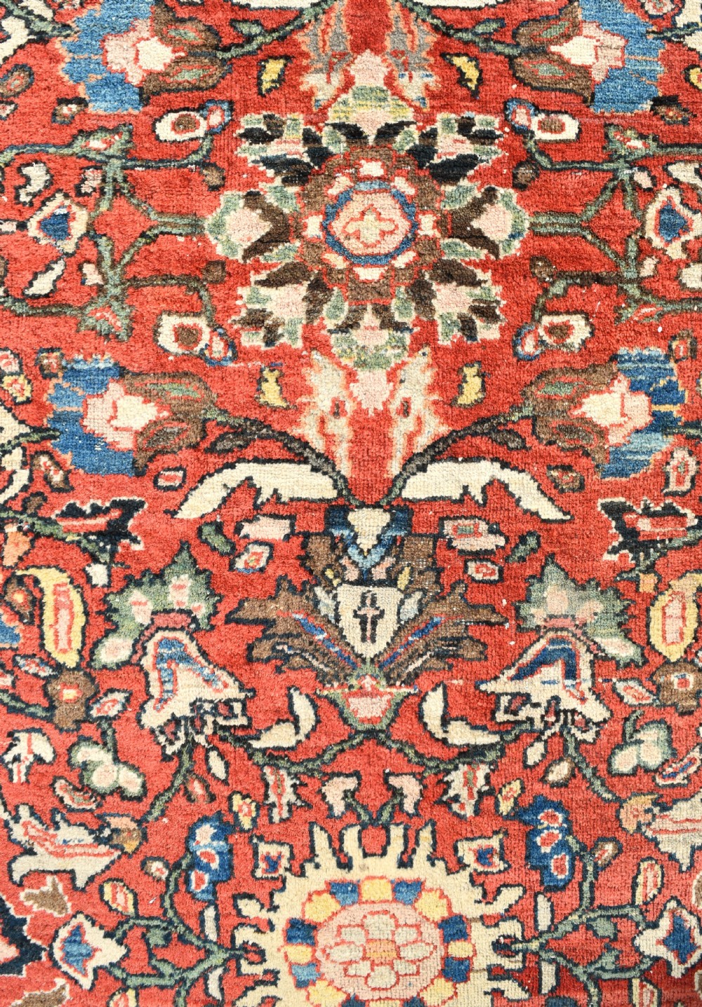 An oversized hand-knotted antique Persian Mahal carpet featuring an intricate terracotta red field and complex dark navy blue floral borders. View IV