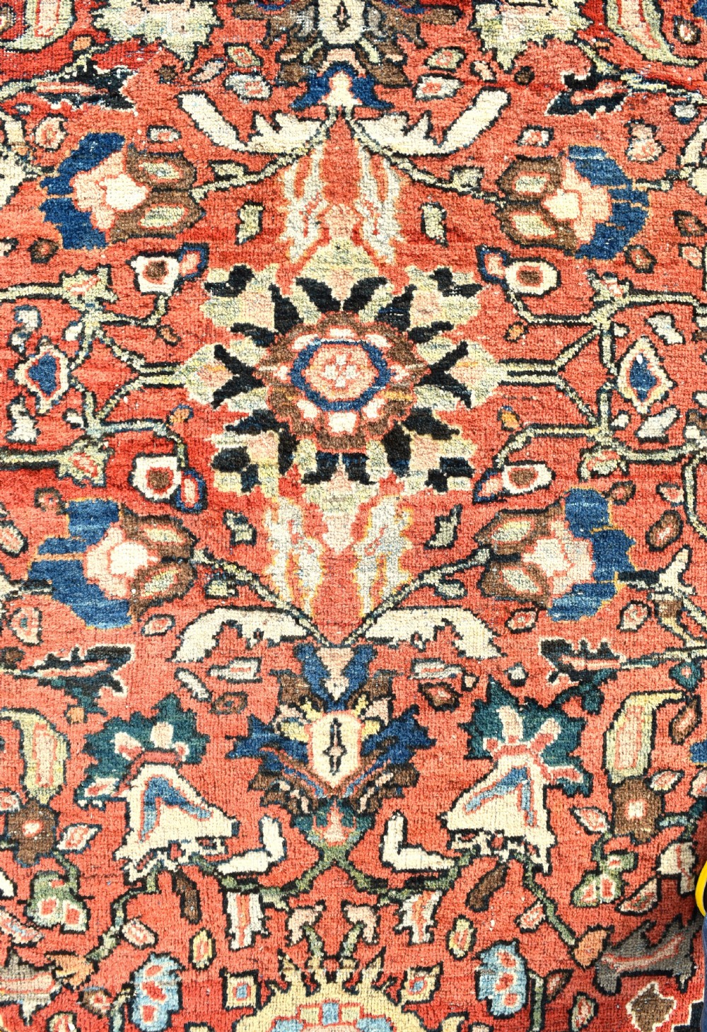 An oversized hand-knotted antique Persian Mahal carpet featuring an intricate terracotta red field and complex dark navy blue floral borders. View VII
