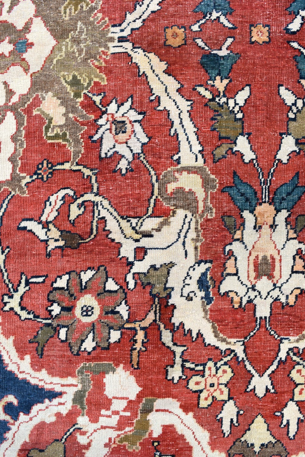 Large antique Ziegler Mahal wool carpet featuring a terracotta field with a central navy blue medallion and ornate floral borders. View X